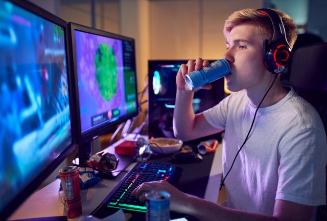 Teenage boy drinking caffeine energy drink