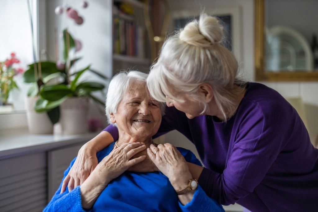 picture of woman hugging older woman