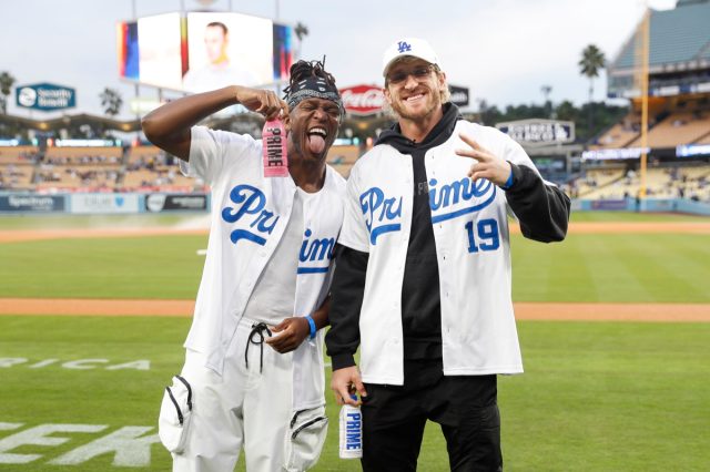 Logan Paul and KSI pose with Prime bottles.